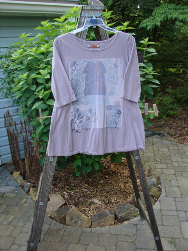 Barclay Three Quarter Sleeved Tee Play Dress Up Lilac Size 1 on a wooden rack, showcasing a sweet neckline and detailed design, made from mid-weight organic cotton, part of a summer collection.