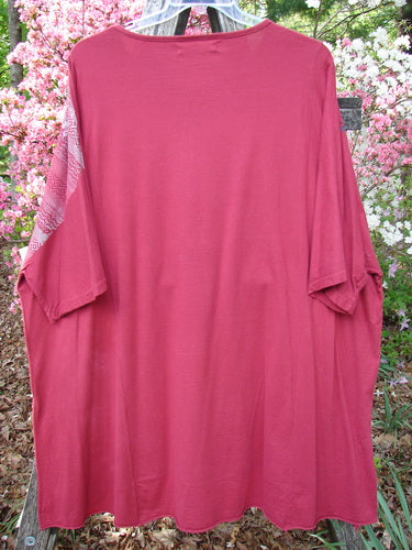 Barclay Art Tunic Tee Trailing Floral Deep Ruby OSFA: Oversized red T-shirt with a rounded neckline, longer tunic length, drop shoulders, and unique upward rounded front hem, hanging outdoors.