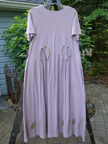 2000 Lulu's Dress Leaf Hyacinth Size 1 on a clothesline, featuring a downward yoked waistline, two inseam drop pockets, and a swingy lower with pleated front darts.