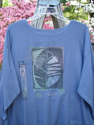 1995 Silk Noile Long Sleeved Top Leaf Fish Butterfly Dusk OSFA, displayed on a hanger, features an abstract design with stylized shapes. The shirt, draped over wood, is framed by flowering shrubs.