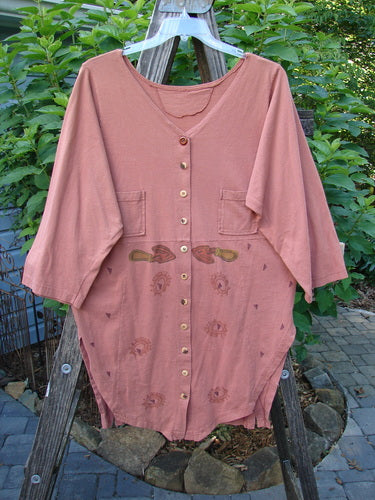 1994 Grasshopper Coat Garden Tools Gourd Size 1, displayed on a wooden ladder, showcasing its wide deep V-shaped neckline, buttoned vents, upper pockets, sectional panels, and shirttail hemline.