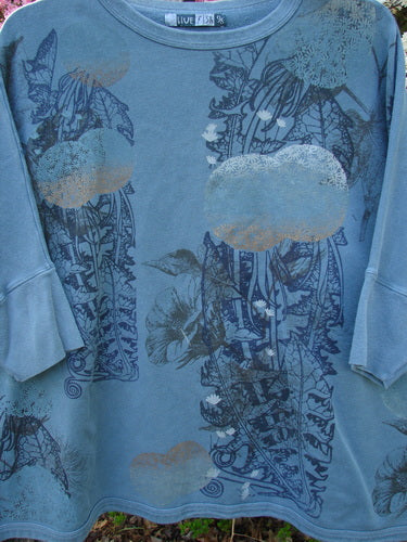 Barclay Fleece Banded Sleeve Dolman Top Moon Garden Sage Dust OSFA hangs outdoors, featuring a slate-blue botanical and cloud motif, rounded neckline, and banded sleeves, embodying Bluefishfinder's vintage and expressive style.