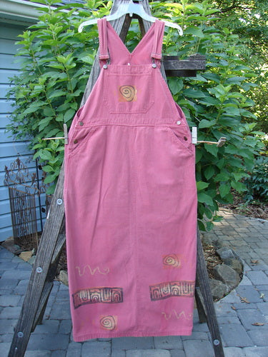 1996 Denim Overall Jumper Rock Journey Ember Size 1 displayed on a wooden stand, featuring adjustable shoulder straps and a painted front bib pocket.