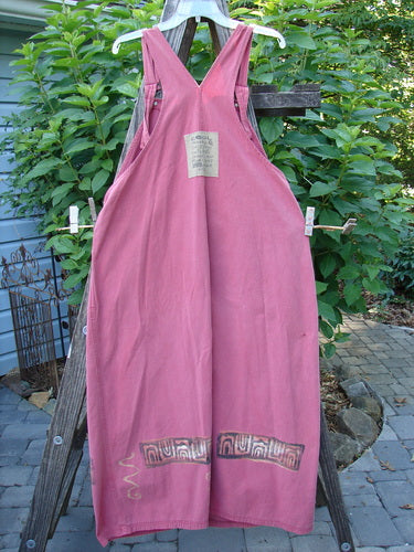 1996 Denim Overall Jumper Rock Journey Ember Size 1 displayed on a wooden stand with adjustable shoulder straps, metal button side adjustments, and a painted front bib pocket.