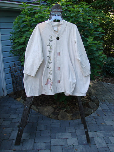 1996 Reprocessed Spring Rain Jacket Garden Vine Birch Bark OSFA displayed on a swinger, featuring a floral design, vintage closure, A-line shape, deep side pockets, and belled side accents.