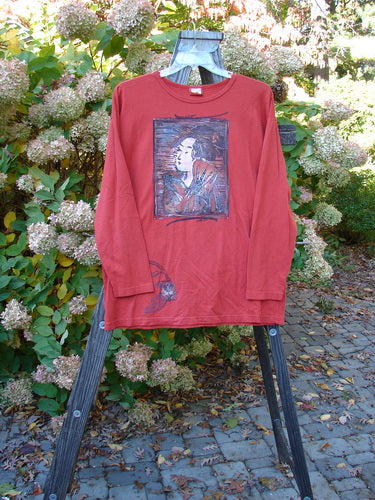 A red long sleeved shirt featuring a Geisha Gal theme paint. Made from organic cotton, this Barclay Long Sleeved Tee is from the Fall Collection in Geisha's Robe. It has a rounded neckline, long cozy sleeves, and a wide slightly longer shape. Bust 50, Waist 50, Hips 50, Length 30 inches.
