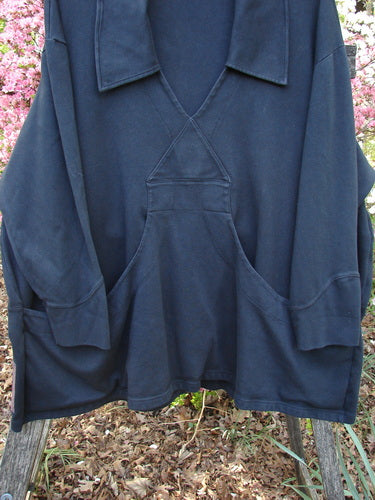 2000 Interlock Peat Bog Top Unpainted Black Size 2 displayed on a wooden bench, featuring a deep V-neck, kangaroo pouch pocket, and double-paneled hem, embodying BlueFishFinder's unique vintage aesthetic.