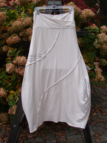 Barclay Cotton Lycra Fold Over Lantern Skirt, cream stripe, size 2, on clothesline. Graduating bell shape, S-shaped stitchery, tap edgings, deep pocket, gray stripe accents.