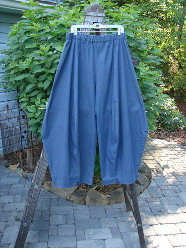 Barclay Light Weight Denim Crop 4 Square Pant Unpainted Indigo Size 2 hanging on a clothes rack, showcasing the unique 3D diamond cut and billowy bottom.
