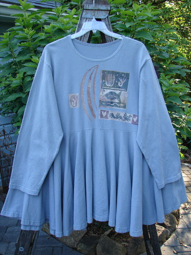 Alt text: 1994 Reprocessed Dance Dress Moon Fish Solstice Blue OSFA with a whimsical moon fish graphic design, long cozy sleeves, and a weighted, swingy lower hem.