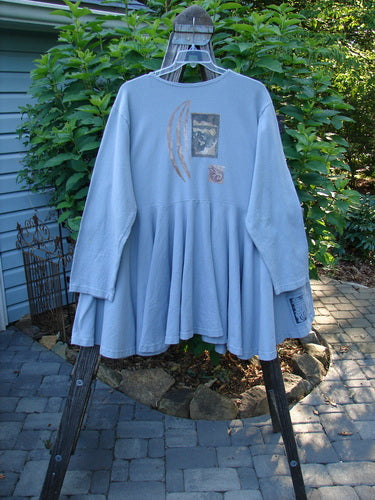 Alt Text: 1994 Reprocessed Dance Dress Moon Fish Solstice Blue OSFA displayed on a hanger, highlighting its long sleeves, drop waist, and heavy, swingy lower hem.