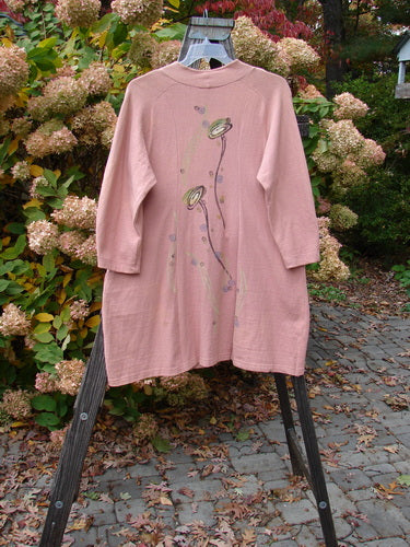 A 1996 Reprocessed Spring Rain Jacket in Petal, altered and in perfect condition. Features include a vintage closure, A-line shape, deep side pockets, and detailed paint and side accents. Bust 40, Waist 46, Hips 56, Length 38 inches.