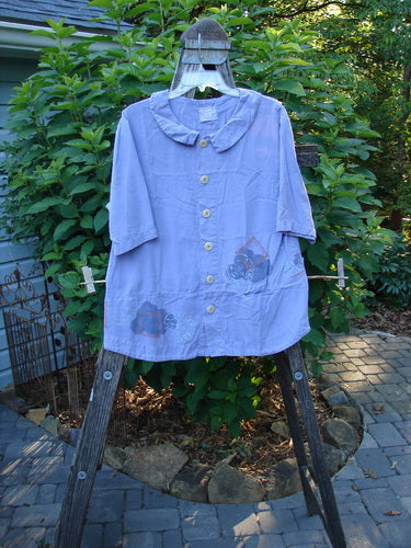 2000 Tencel Camp Shirt Airmail Twilight Size 0 displayed on a hanger, highlighting its Peter Pan collar, oversized buttons, front drop pocket, and lower widening seam for a flowing fit.