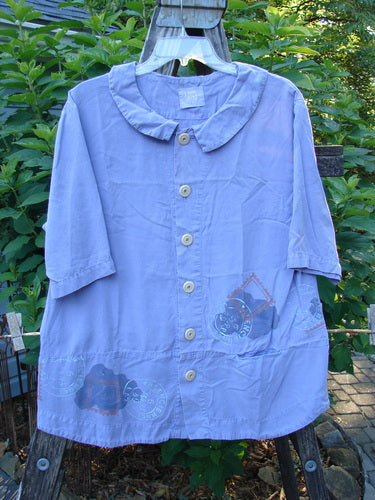 2000 Tencel Camp Shirt Airmail Twilight Size 0 hanging outdoors, showcasing its Peter Pan collar, oversized buttons, front drop pocket, and full-paneled sweep.