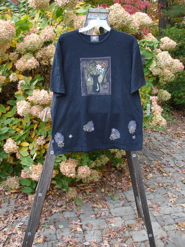 2000 Artist Choice Short Sleeved Tee with floral vase paint design on black organic cotton jersey. Size 1.