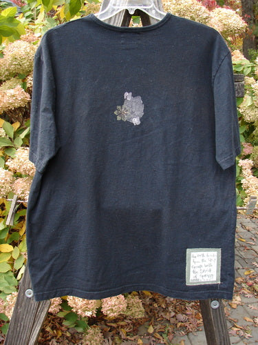 2000 Artist Choice Short Sleeved Tee with floral vase design on black fabric, made of organic cotton jersey. Size 1.