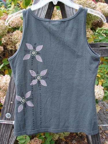 Barclay Cotton Lycra Tiny Tank Triple Floral Grey Storm Size 0: A medium-weight grey tank top with a triple floral pattern, made from organic cotton and lycra.