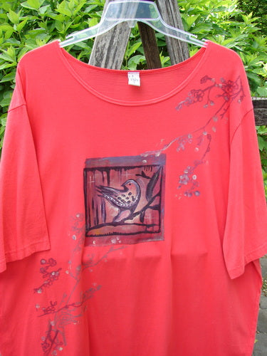 Barclay Short Sleeved Studio Tee Birdy Branch Pomegranate Size 3, featuring wide sleeves and a stylized bird motif, highlighted by twig-and-blossom accents, hangs outdoors on a clear hanger.