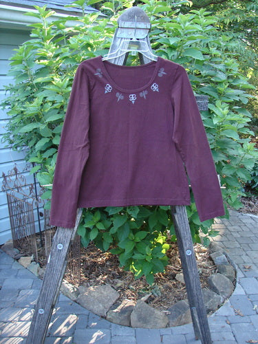 1999 Cotton Lycra Long Sleeved Layering Top Necklace Red Wine Size 0 displayed on a wooden rack, showcasing its full-length sleeves and super stretch fabric, perfect for layering.