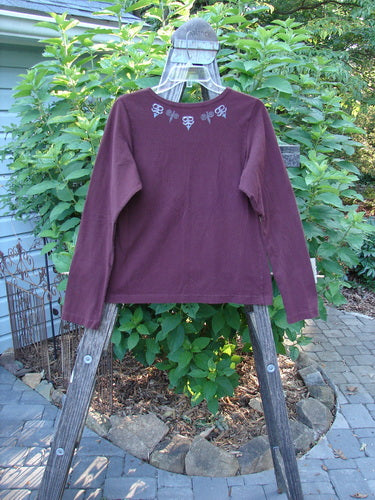 1999 Cotton Lycra Long Sleeved Layering Top Necklace Red Wine Size 0 displayed on a wooden rack, highlighting its full-length sleeves and stretch fabric, perfect for layering or wearing alone.