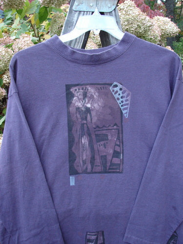 1997 Long Sleeved Tee Spirit Drum Ionic Size 1: A purple long sleeved shirt with a painted Spirit Woman and Drum theme. Cozy and stylish.