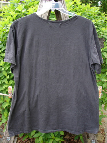 Barclay Fiona Straight Tee Modern Vase Storm Size 0, showcased on a hanger outdoors, features a rounded neckline and wide sleeves, emphasizing its generous, straight shape made from organic cotton.