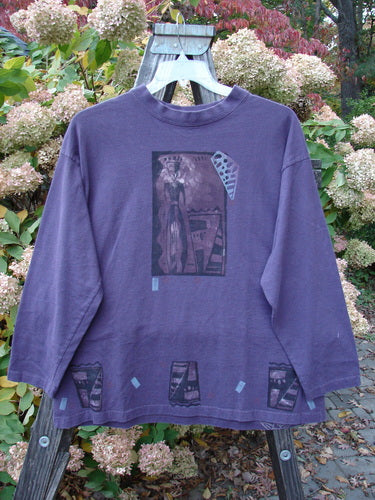 1997 Long Sleeved Tee Spirit Drum Ionic Size 1: A purple long sleeved shirt with a spirit woman and drum theme paint design.