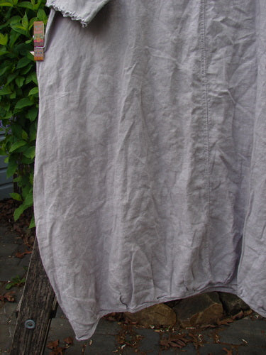 Barclay Cotton Sleeved Frenchtown Studio Dress Wild Flower Rice Paper Size 0 hanging outdoors, showcasing its medium-weight linen and unique design details like the rounded, double-pleated neckline and billowy pockets.
