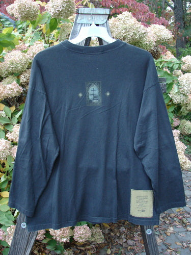 1997 Long Sleeved Tee Stone Door Cast Iron Size 1: A long sleeved shirt on a swinger, featuring a thicker mid weight cotton, wider ribbed neckline, drop shoulders, cozy longer sleeves, and a square box shape. Intriguing stone door theme paint adds a unique touch.