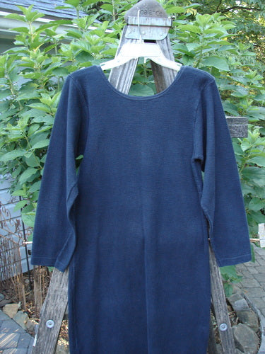 Image of the 1991 Rib Thermal The Skinny Dress in Charcoal, showcasing its straight linear shape, long sleeves, and rounded neckline, displayed on a clothes rack, emphasizing its unique cozy cotton thermal rib fabric.