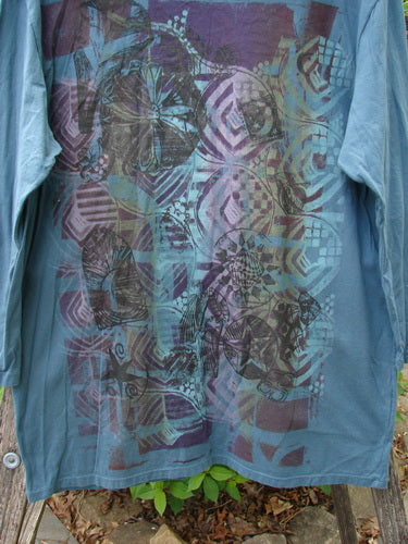 Barclay Long Sleeved Studio Tee Flower Garden Block Tealen Size 0, featuring abstract geometric and organic prints, draped over wood, showcasing a boxy shape and thinner neckline in organic cotton.