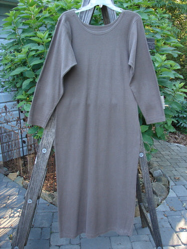 1991 Rib Thermal The Skinny Dress Unpainted Nut Brown Altered OSFA displayed on a wooden ladder with long sleeves and a rounded neckline, showcasing its straight linear shape and cozy cotton texture.