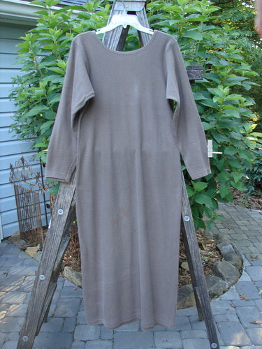 Alt text: 1991 Rib Thermal The Skinny Dress Unpainted Nut Brown Altered OSFA displayed on a wooden ladder, showcasing its long sleeves and straight linear shape.
