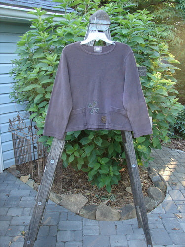 1999 Thermal Boatneck Pullover Chick Currant Size 0 displayed on a wooden ladder, showcasing its long sleeves, crop boxy A-line shape, two front billowy pockets, and excellent drape.