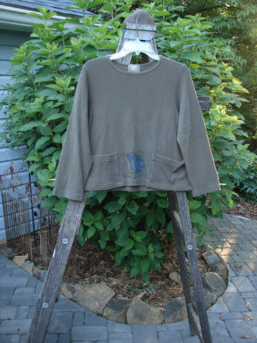 1999 Thermal Boatneck Pullover Fall Leaf Mud Size 0 displayed on a wooden ladder, showcasing its A-line shape, billowy pockets, and cropped, boxy design, exemplifying BlueFishFinder's vintage collection.