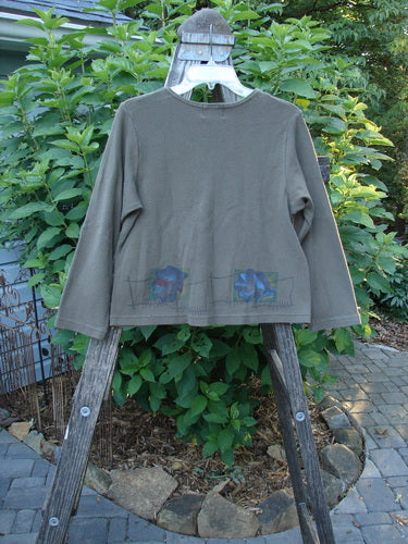 1999 Thermal Boatneck Pullover Fall Leaf Mud Size 0 displayed draped over a wooden ladder, highlighting its A-line shape, front billowy pockets, and cozy thermal fabric for fall.