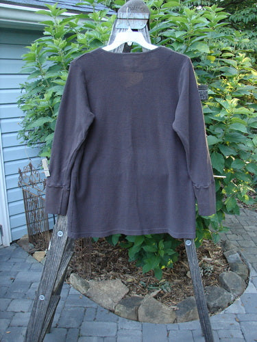 2000 Thermal Lu Top Unpainted Brum Size 1 displayed on a hanger, showcasing its long sleeves, ribbed cuffs, rubberized buttons, and slightly A-line shape with a ribbed texture.