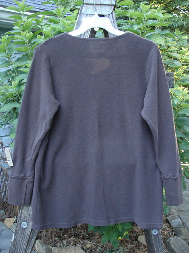 2000 Thermal Lu Top Unpainted Brum Size 1 displayed on a hanger, showcasing ribbed cuffs, rubberized buttons, and a slightly A-line shape with a lightweight, draped thermal fabric.