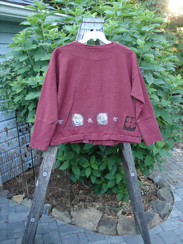 1999 Cottage Cardigan Heart Cup Cinnamon Size 0 displayed on a wooden ladder, highlighting its boxy shape, ribbed lower sleeves, and oversized buttons.