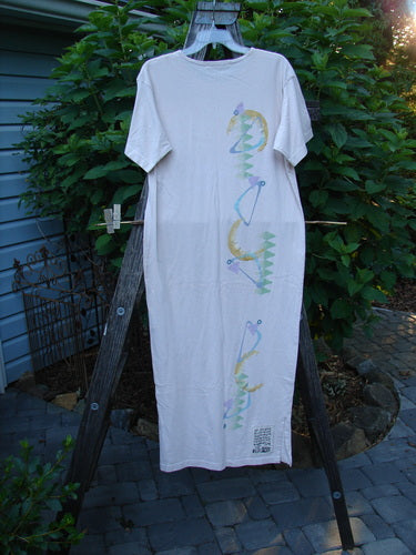 1996 Long Tee Dress Half Moon Birch Bark Size 0 on a clothes rack, showcasing its rounded paneled neckline, short wide sleeves, and seamless front and back design.