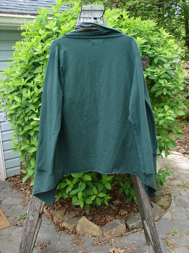 Barclay Cotton Lycra Gather Collar Open Front Jacket in Golden Forest, displayed on a wooden A-frame outdoors, featuring a unique drawcord neckline, open front, and dual side pockets.