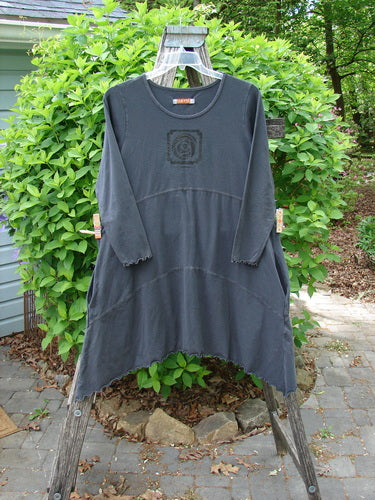 Barclay Cotton Lycra Shape Dress Feather Rose Raven Size 1 displayed on a wooden frame. Features asymmetrical hem, scalloped trim, centered feather rose motif, and deep side pockets, embodying Bluefishfinder's unique vintage style.