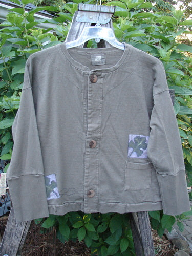 1999 Cottage Cardigan Forest Leaf Mud Size 0 displayed on a hanger, showcasing ribbed lower sleeves, double-paneled back shoulder, square boxy shape, drop shoulder seams, and three oversized vintage buttons.