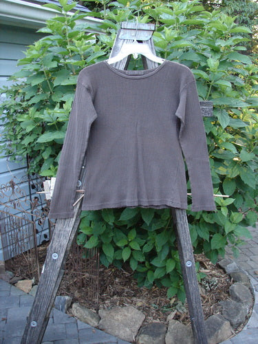 1998 Pointelle Long Sleeved Undertop Top Unpainted Stick Size 1 displayed on a wooden rack, showcasing its soft rib knit pattern, rolled neckline, and cozy sleeves, ideal for layering.