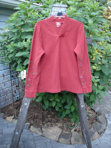 2000 Thermal Boann Top Bubble Bittersweet Size 1 displayed on a wooden rack, features a thick ribbed V neckline, tapered cuffs, bubble detail, and a slightly tapered waist and hem.