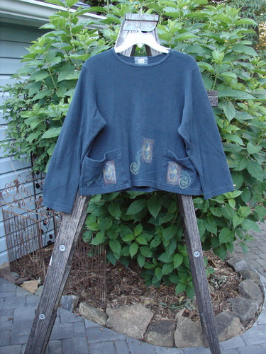 1999 Thermal Boatneck Pullover Heart Peacock Size 1 on a wooden rack, showcasing its A-line shape and two front billowy pockets.