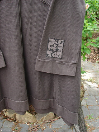 Barclay Patched Thermal Cowl Neck Reverse Stitch Pocket Pullover Bark Size 0, featuring a waffle-knit texture, draped on a branch, showcasing its unique hemline, exterior stitching, and nature-inspired sleeve patch.