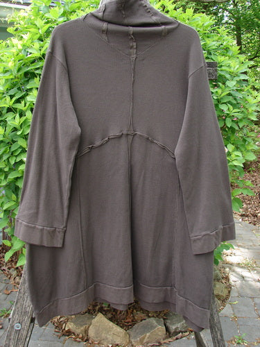 Barclay Patched Thermal Cowl Neck Reverse Stitch Pocket Pullover Bark Size 0, features a cozy cowl neck, unique curly stitchery, and sectional panels, hanging against lush green shrubbery.