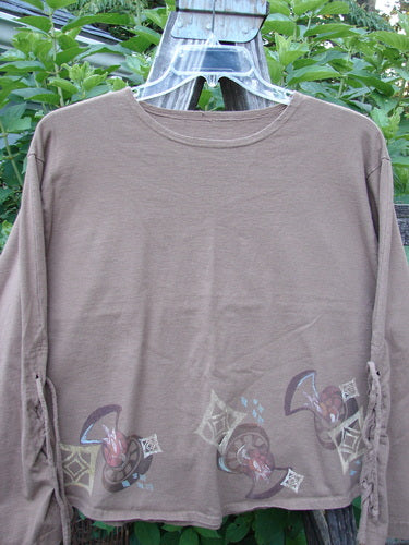 1997 Chandra Top Holiday Diamond Mandorla Size 1: long-sleeved brown shirt with intricate sleeve lacings, wide hemline, rolled neckline, diamond theme paint, drawcord back, and signature Blue Fish patch.