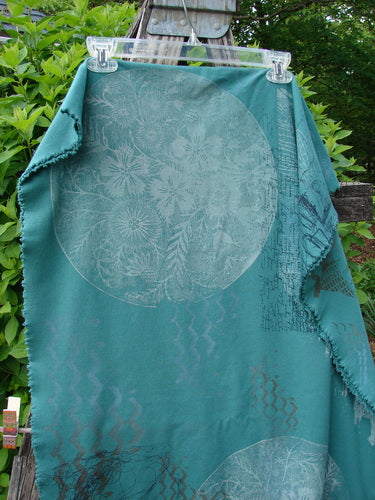Barclay Heavy Weight Organic Sweatshirt Art Wrap Moon Garden Emerald OSFA draped over a rustic ladder, showcasing large floral motifs and subtle patterns, highlighting its artistic design and generous shape.